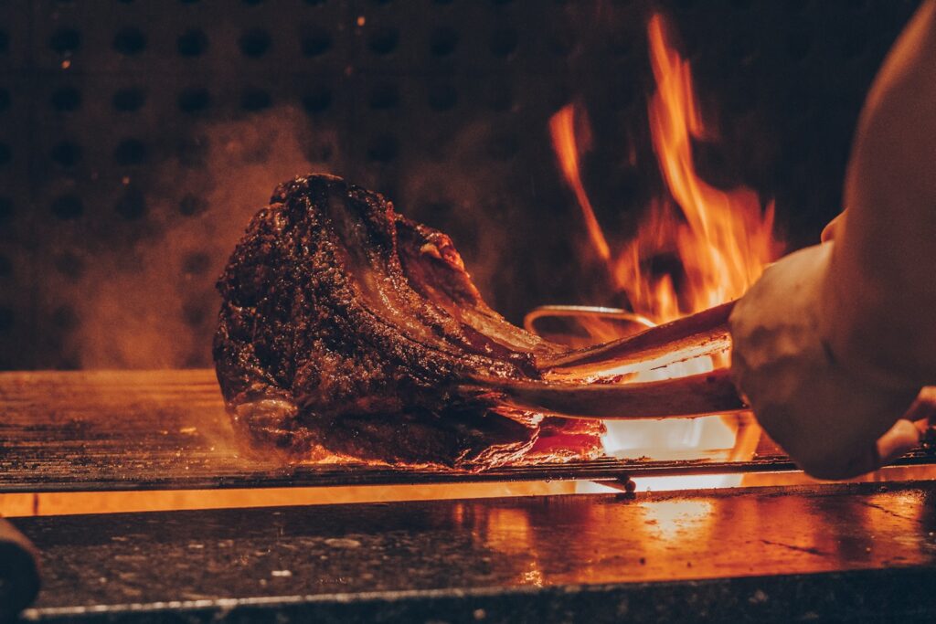 person barbecuing meat